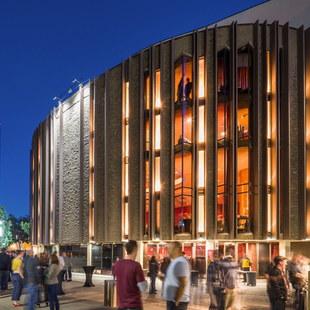 Exterior view of the San Diego Civic Theatre at night, illuminated and bustling with visitors.